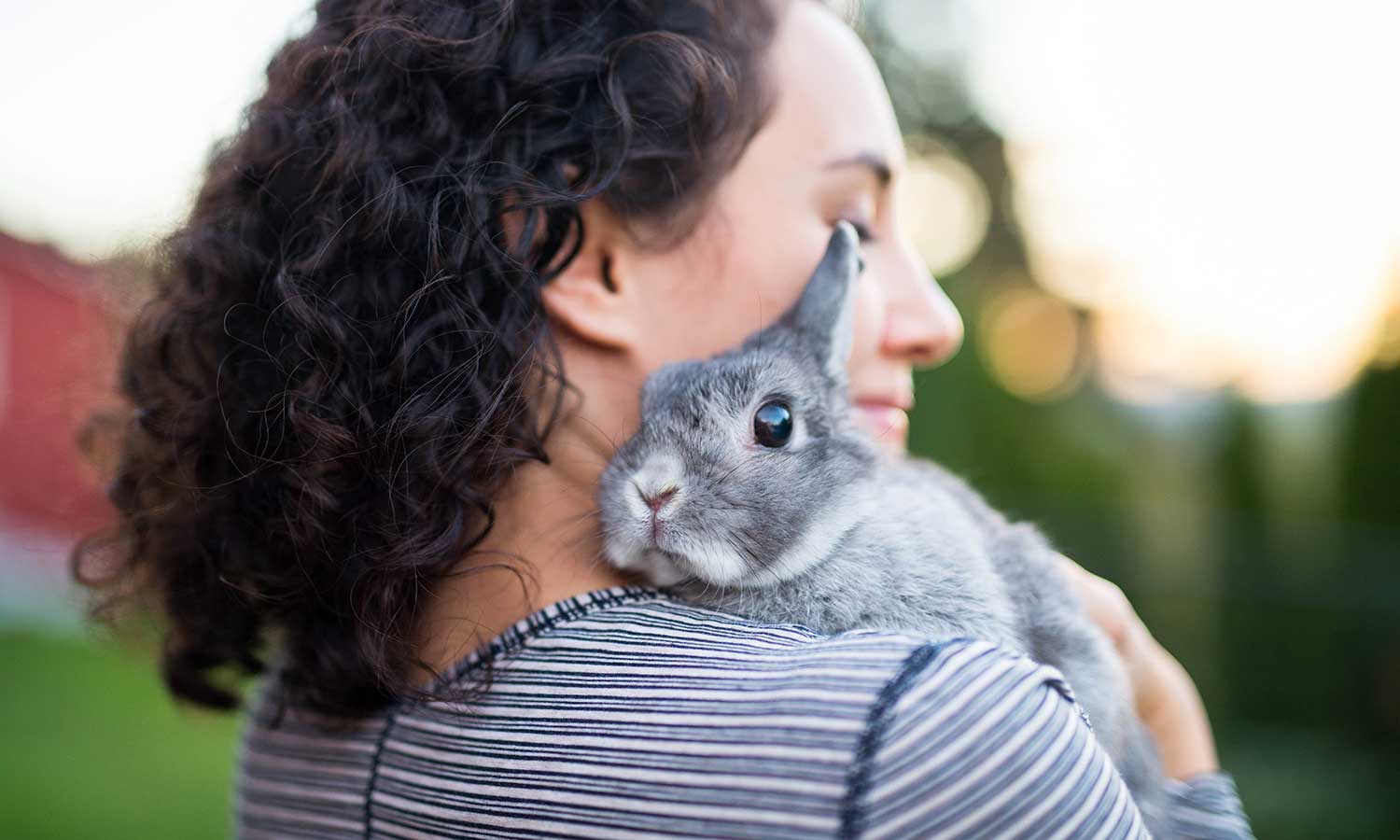 A woman with a rabbit on her shoulder